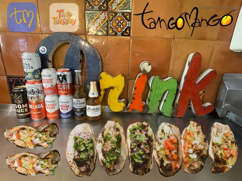 A spread of tacos and canned drinks on the Tango Mango counter